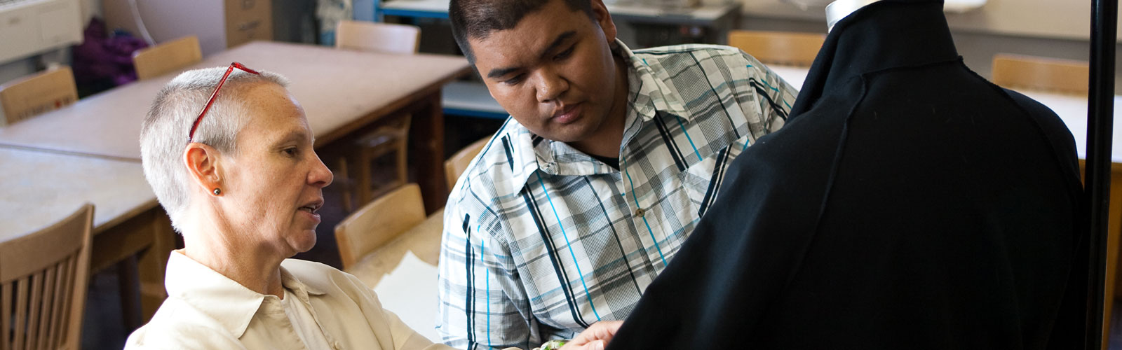 student and professor examining blazer