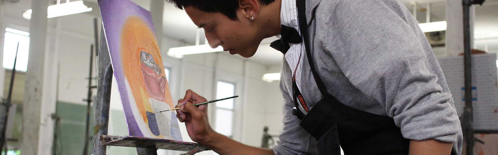 student painting colorful picture on canvas