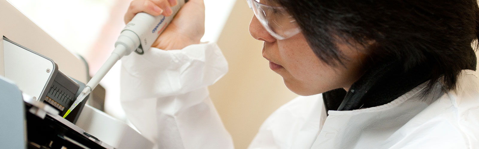 woman in lab coat working with chemicals