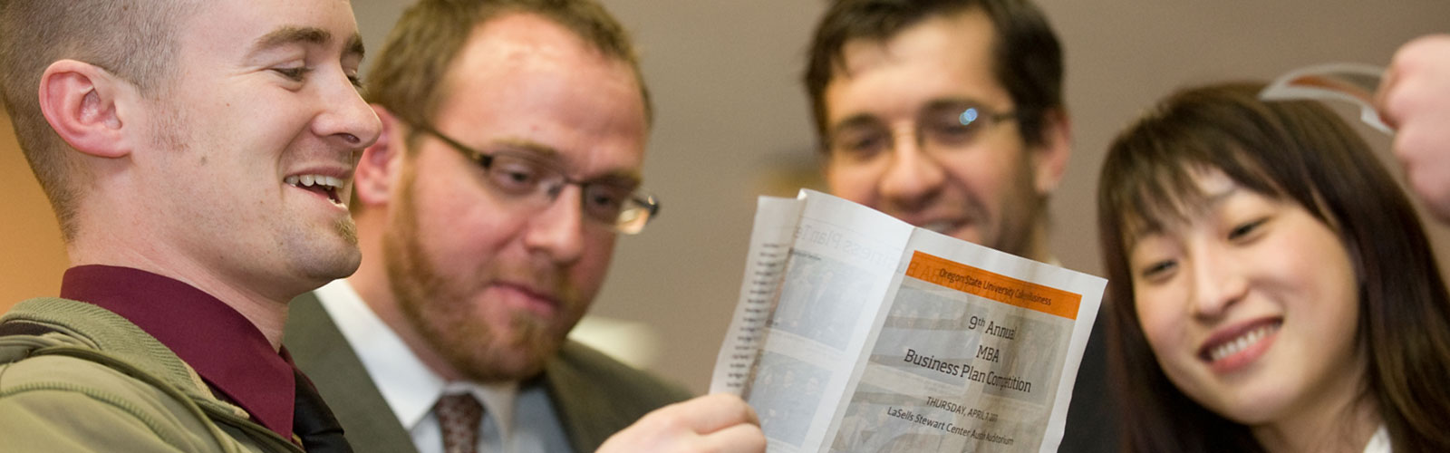 man going over a document with group of students 