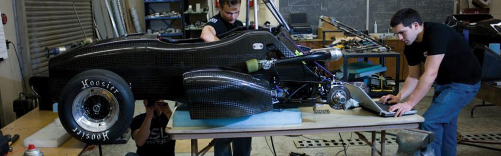 twp men building black car