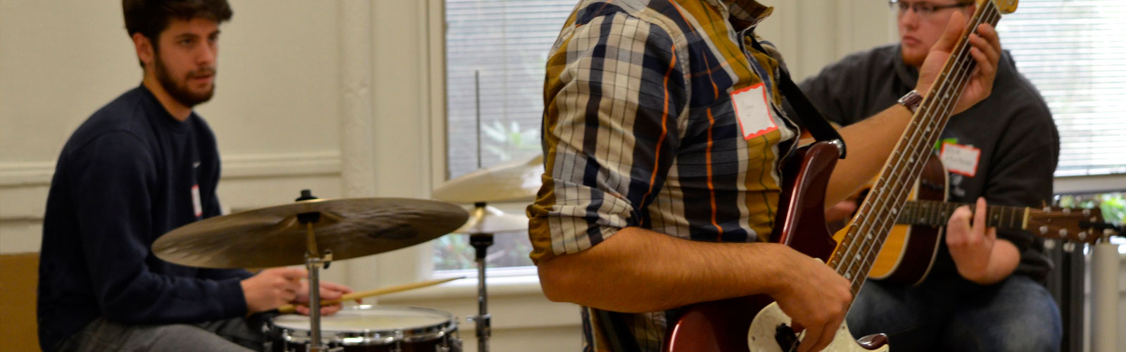 3 students playing in a band